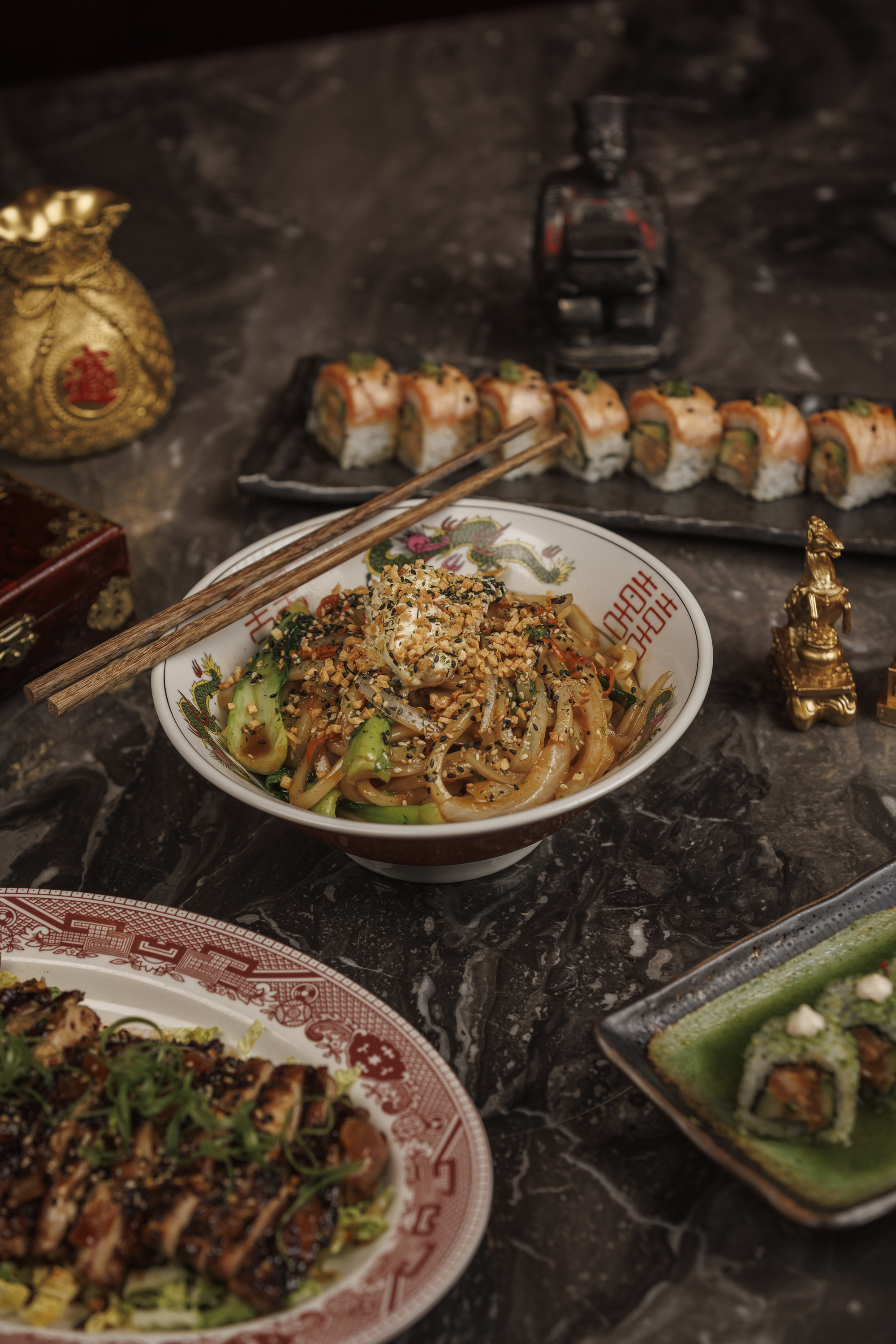 Garlic Noodles featuring stir-fried udon noodles, baby bok choy, Yu Xiang garlic sauce, miso hot hon 