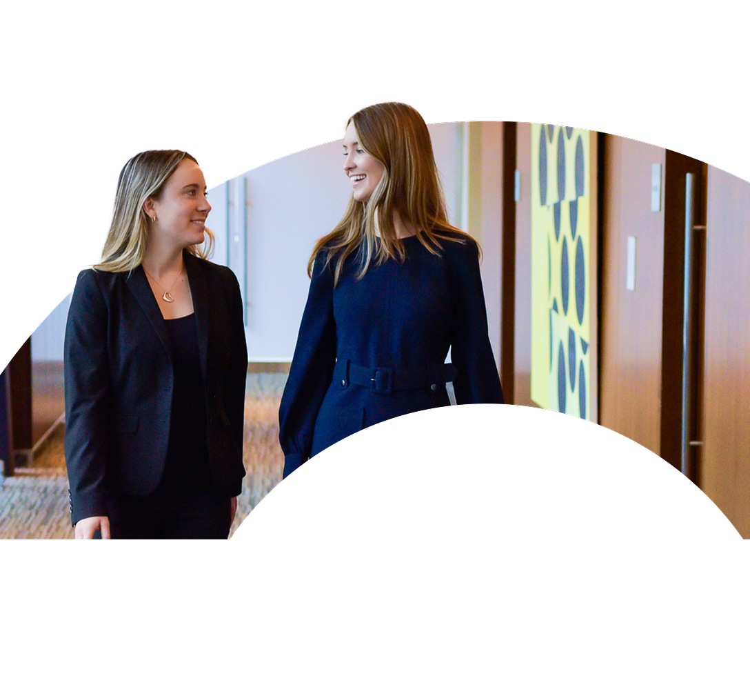Two O'Hanlon Wealth Management team members displayed in the curve of a large letter O.