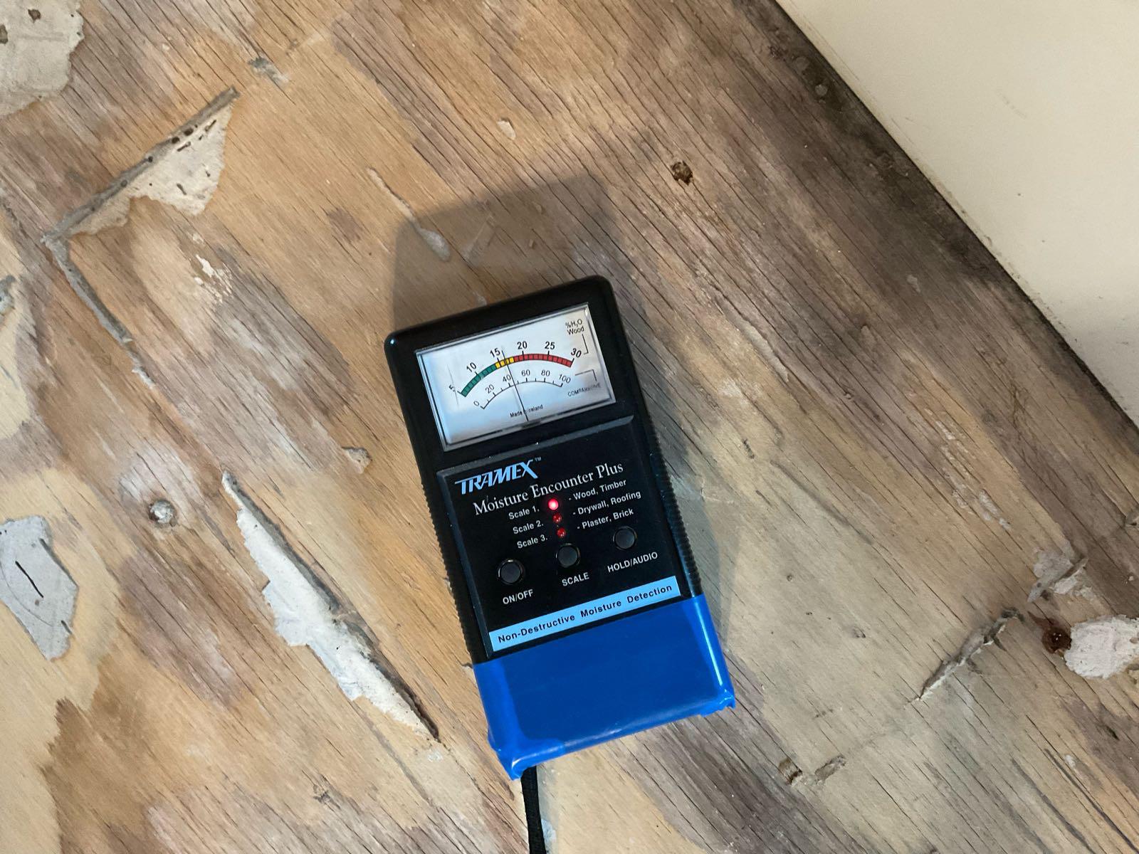 SERVPRO moisture meter detecting moisture in flooring.