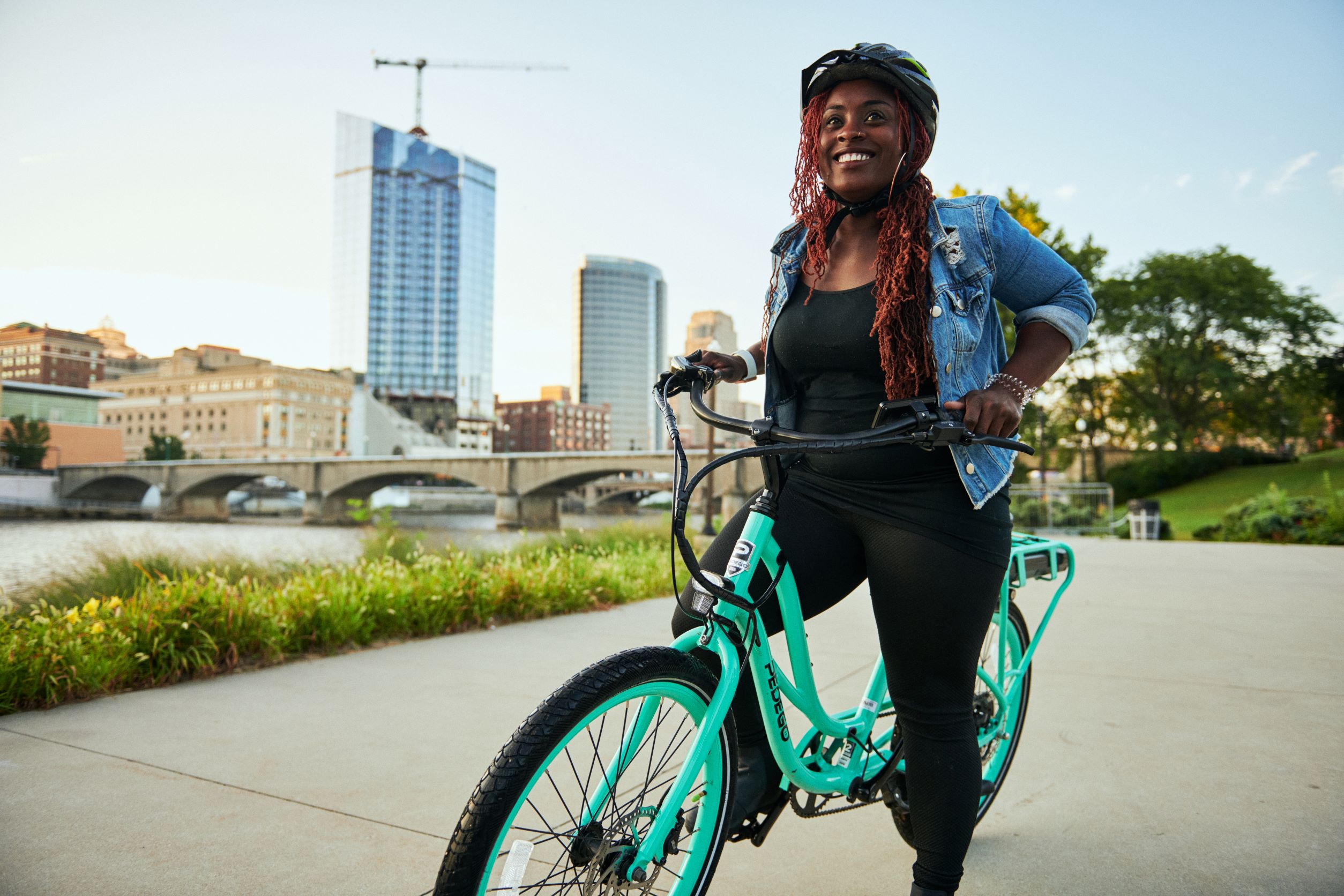 Woman riding a Pedego ebike in downtown Grand Rapids