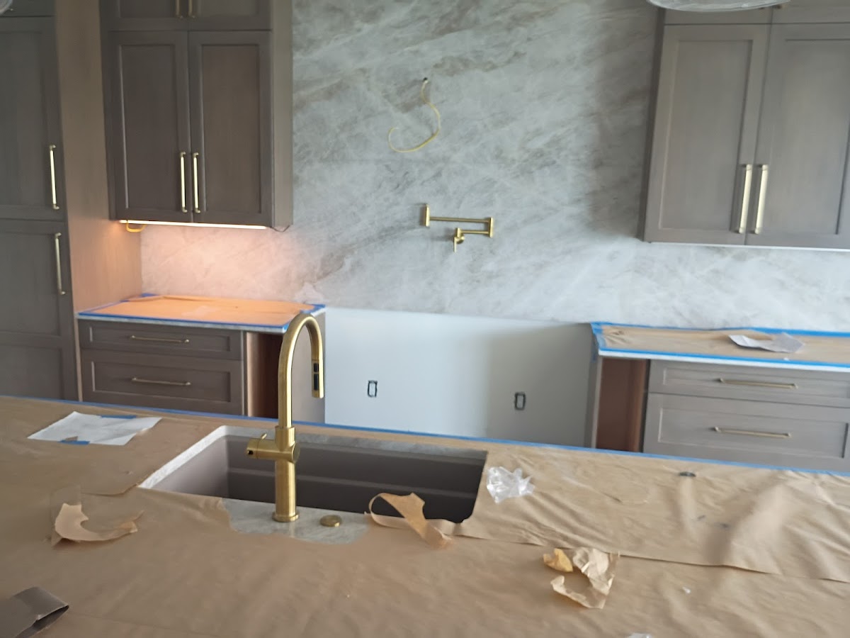 Bathroom renovation in progress with bathtub, vanity area, and plumbing fixtures being installed or updated.