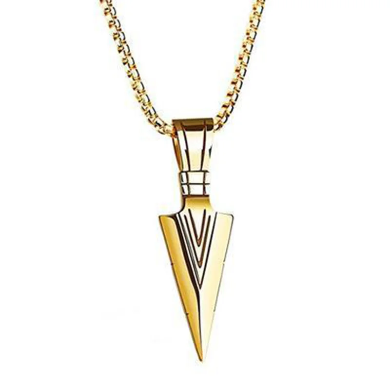 A golden arrow pendant necklace is shown against a white background.