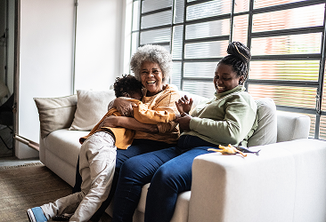 A multigenerational family laughing together.
