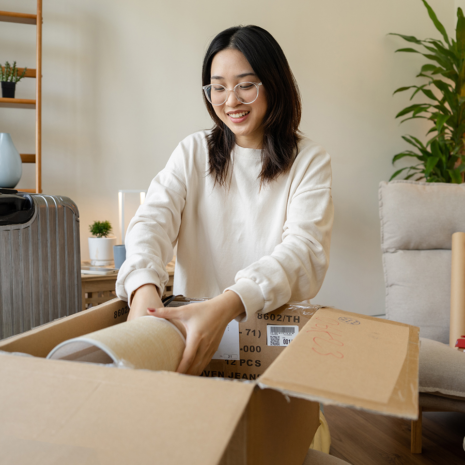 A woman holding an item in an open box.