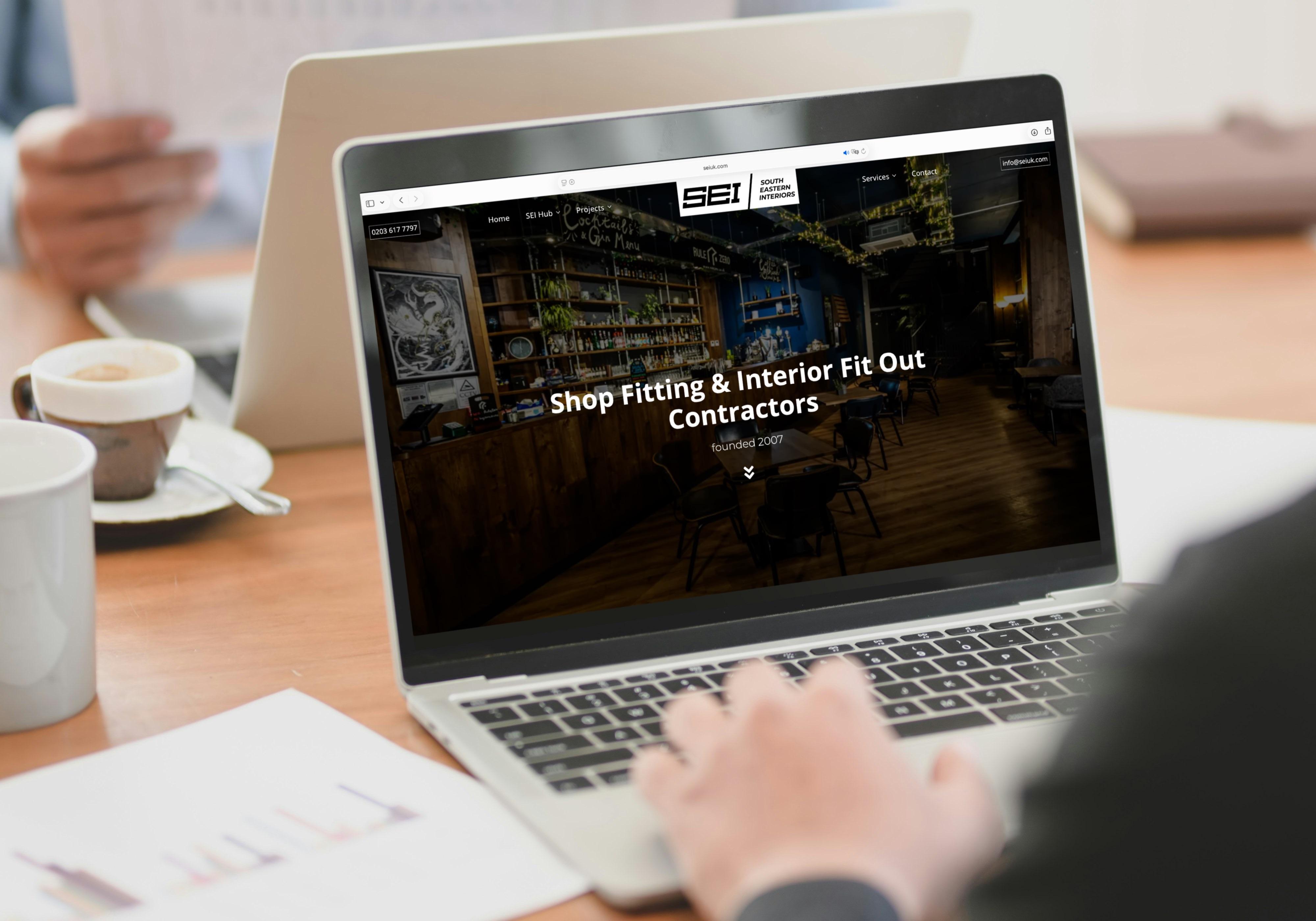 SEIUK shop fitting company website designed by Digiwings Shrewsbury on laptop