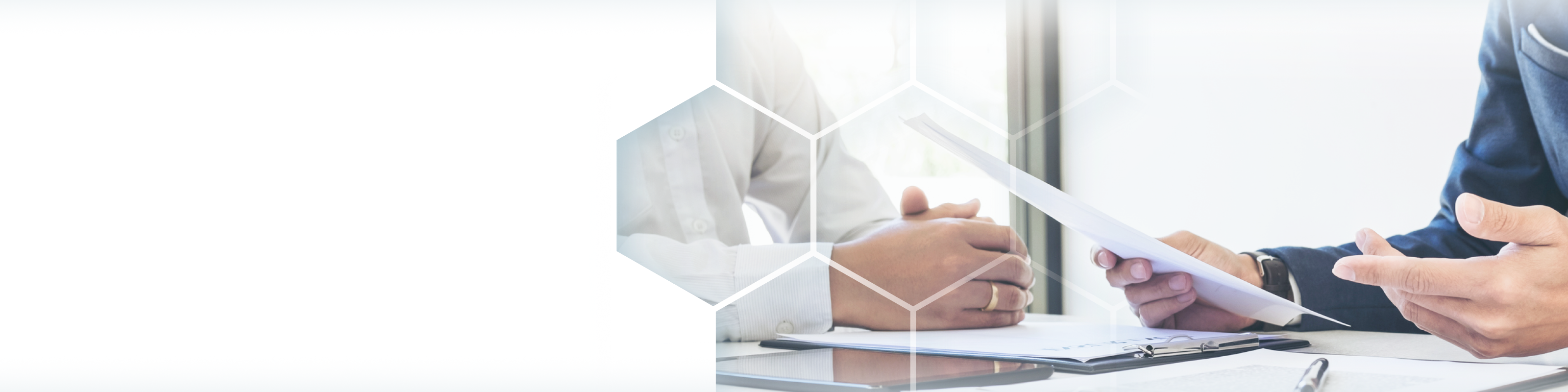 Close up shot of two people reviewing and discussing documents.