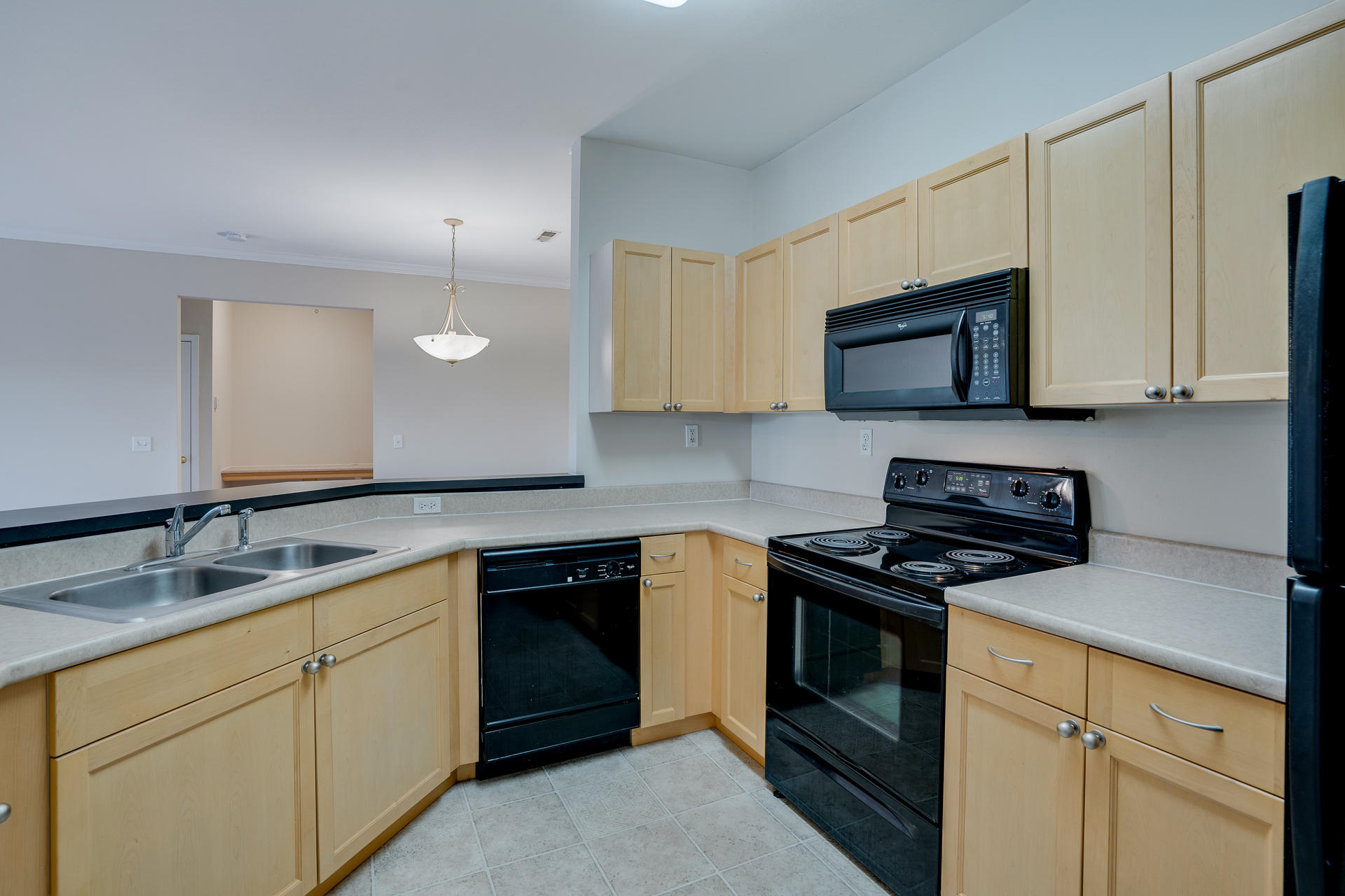 Spacious Fully-Equipped Kitchen With Black Appliances