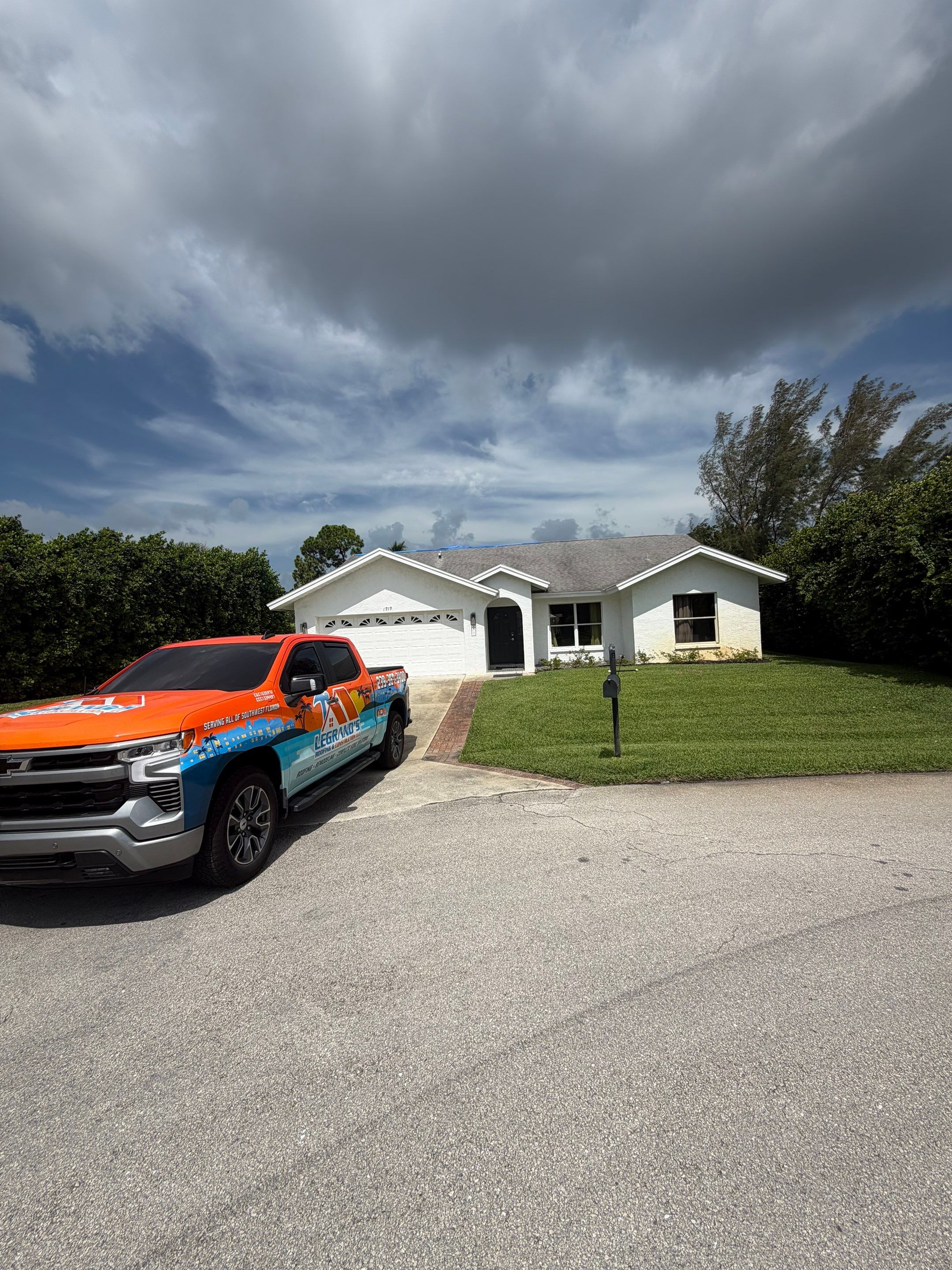 LeGrand’s Roofing truck parked outside a single-story home before beginning residential roofing work 