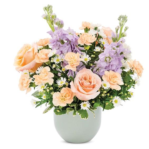 She's On My Mind - Let her know she is always on your mind with this arrangement of peach roses, mini peach carnations and white monte casino in a charming matte pot.