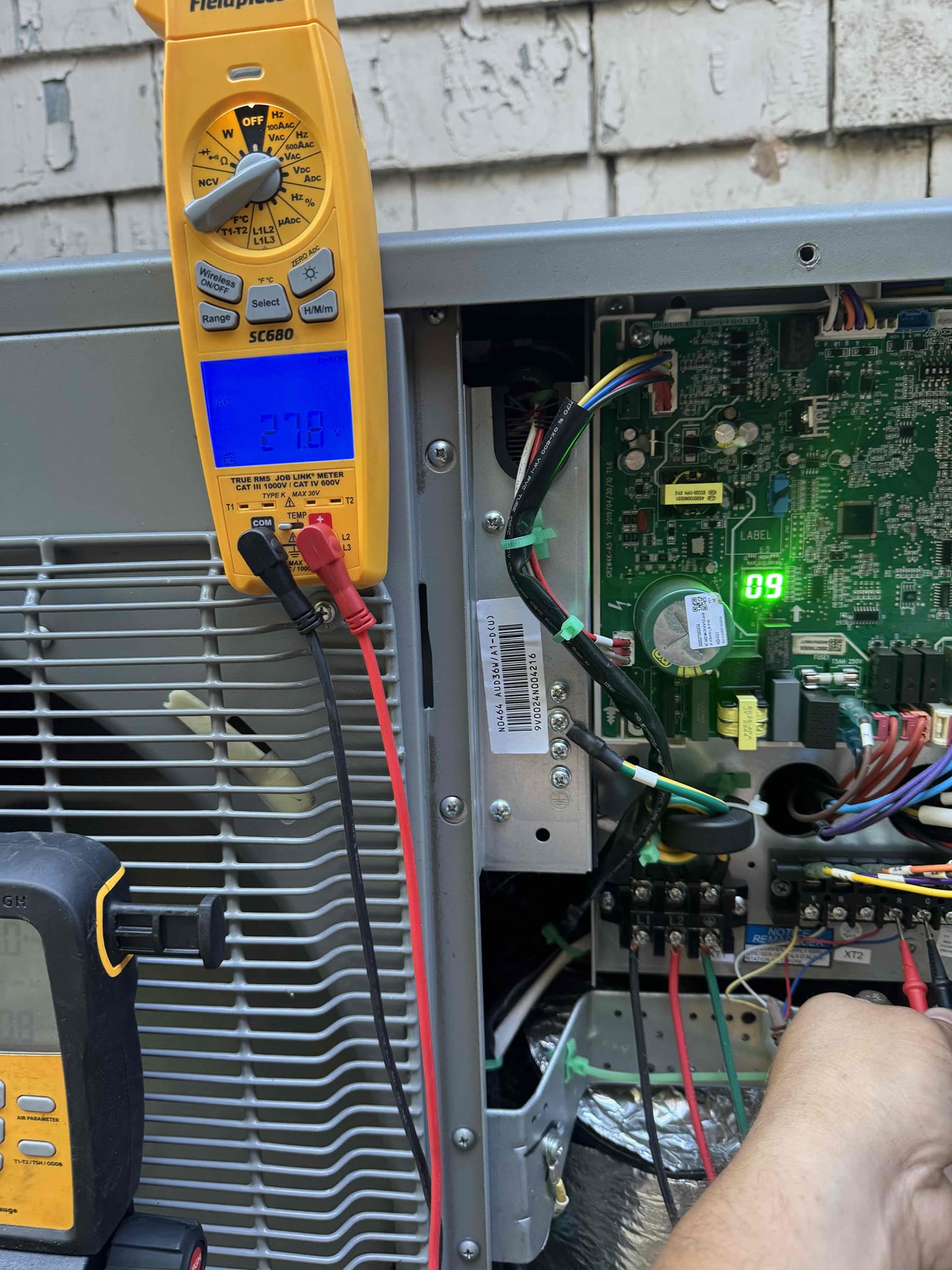 A newly installed air conditioning condenser unit with an Affordable Heating and Air service sticker, positioned on a concrete pad outside a residential home in Ventura County.
