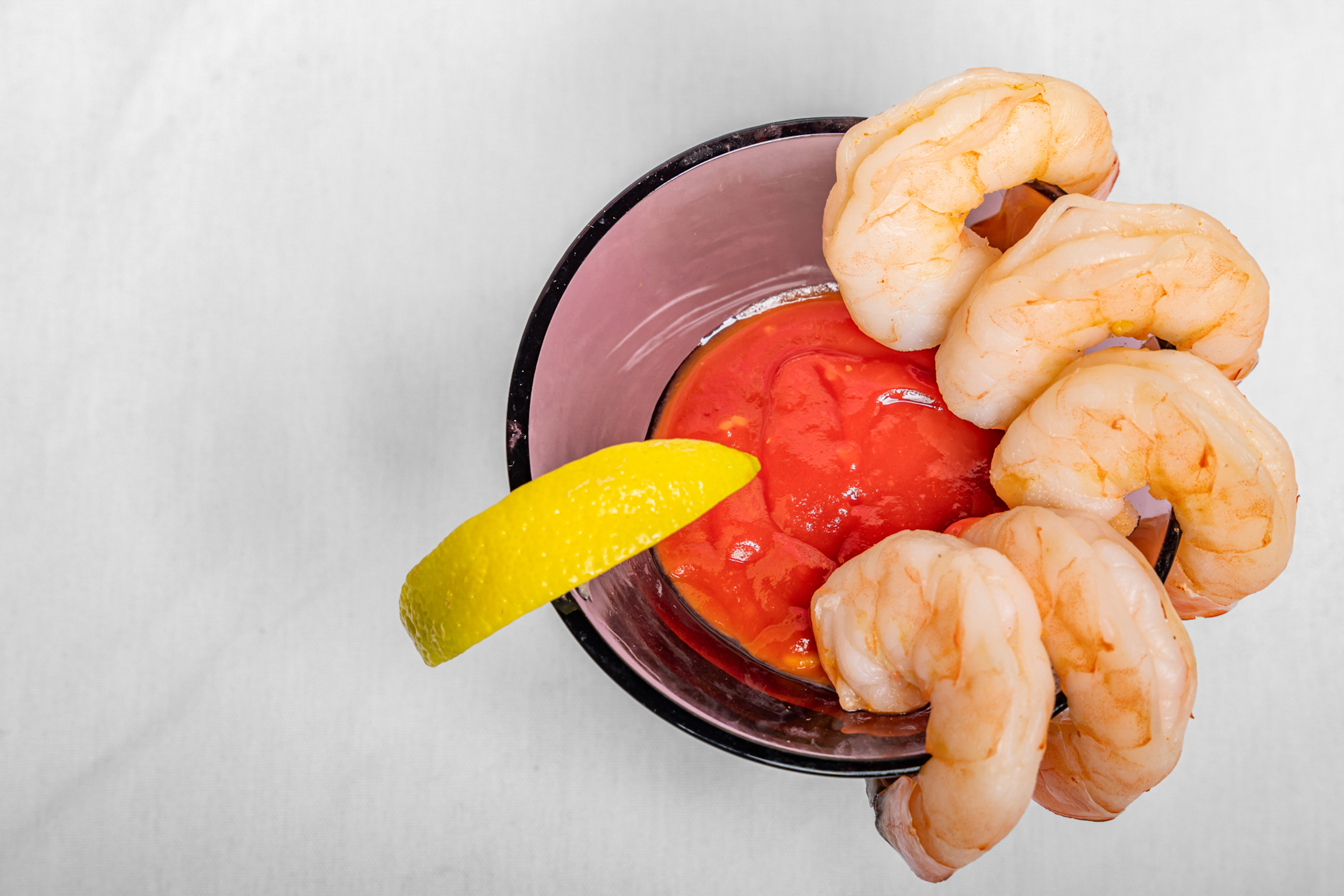 Chilled, perfectly cooked shrimp served with a zesty cocktail sauce for a refreshing bite.
