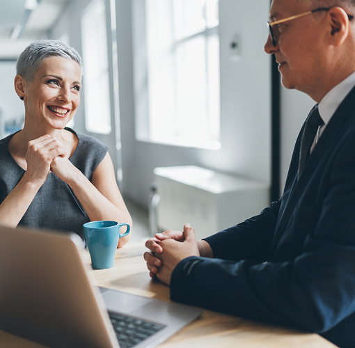 A wealth management professional speaking with a client.