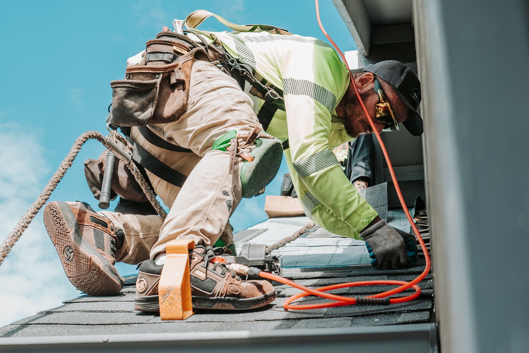 Roofer installing wall flashing 
