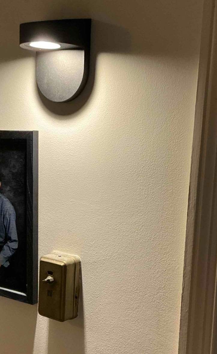 A modern LED wall sconce installed in a Bryn Mawr, PA hallway by Thomas Edison Electric. The downlight design provides soft ambient illumination perfect for nighttime navigation.