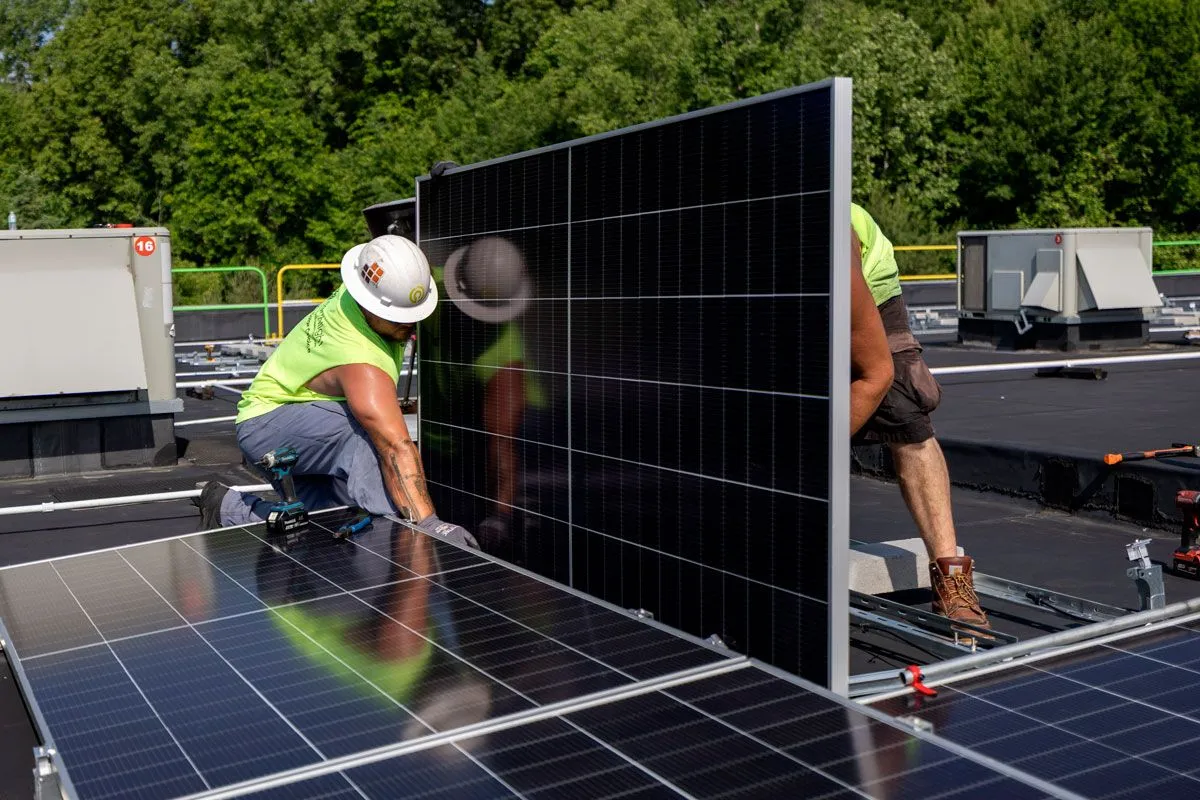 Earthlight crew installing solar panels on a rooftop