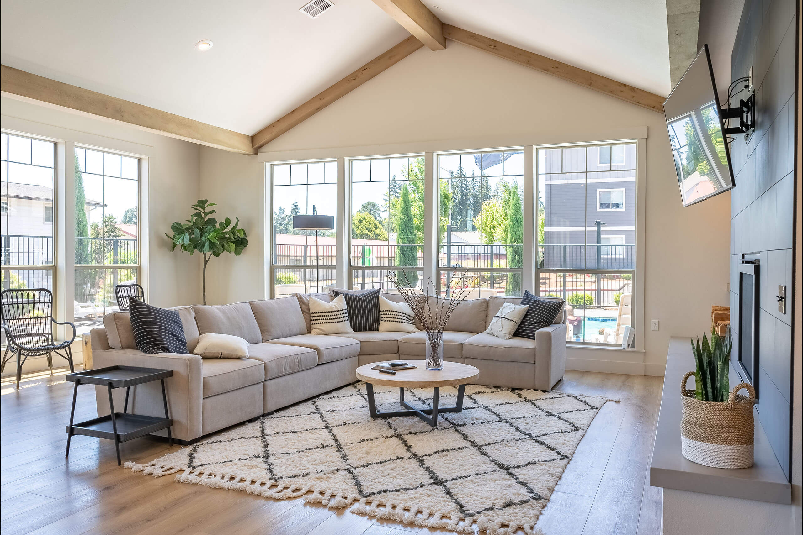A living room with a couch, a coffee table, and a TV.