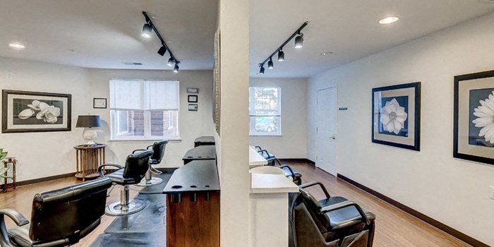 a living room with a bar and chairs and a table