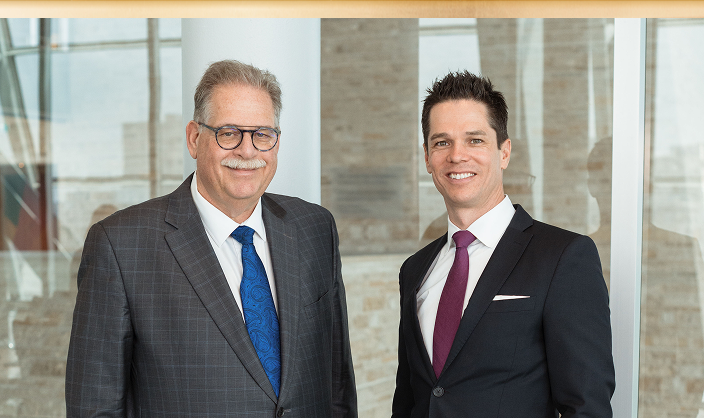 Paul Winestock and Danny Childerhouse standing side by side in the office.