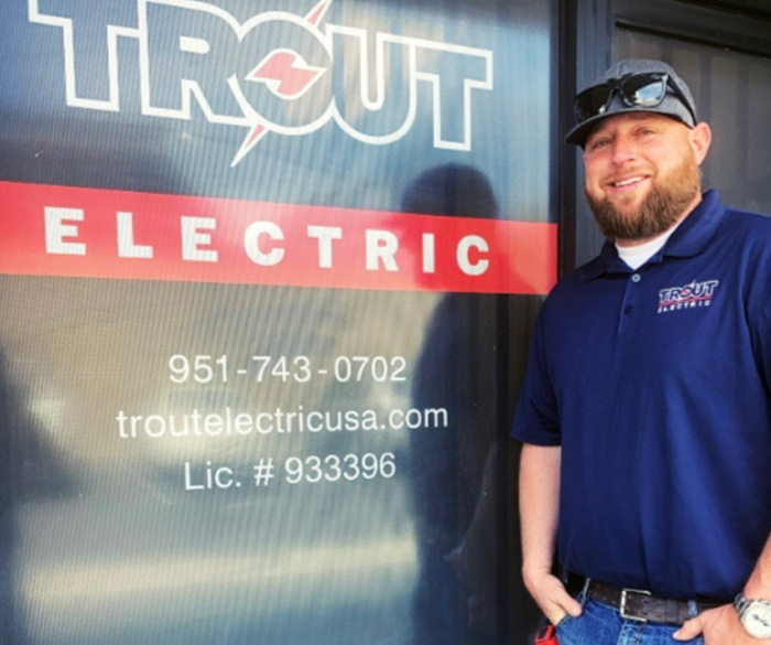 Trout Electric electrician standing in front of the office
