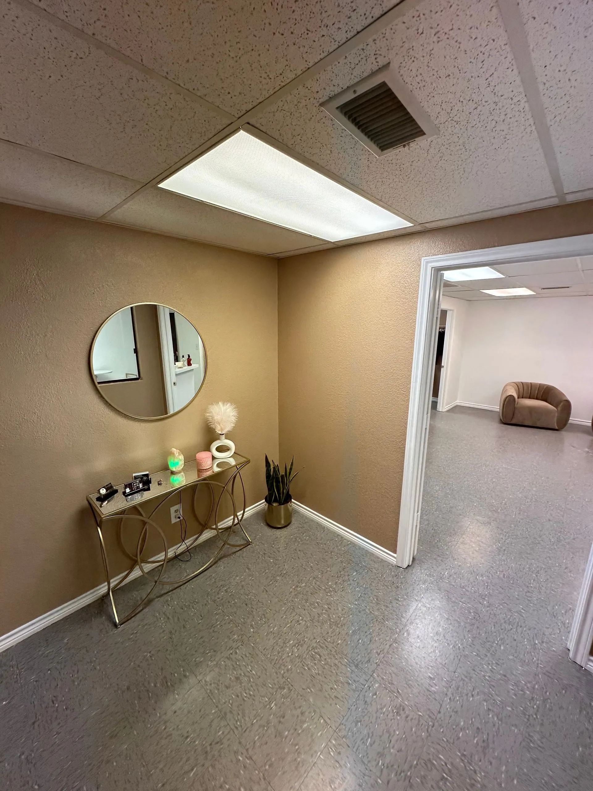 Commercial office reception area before renovation featuring neutral walls, suspended ceiling, simpl 