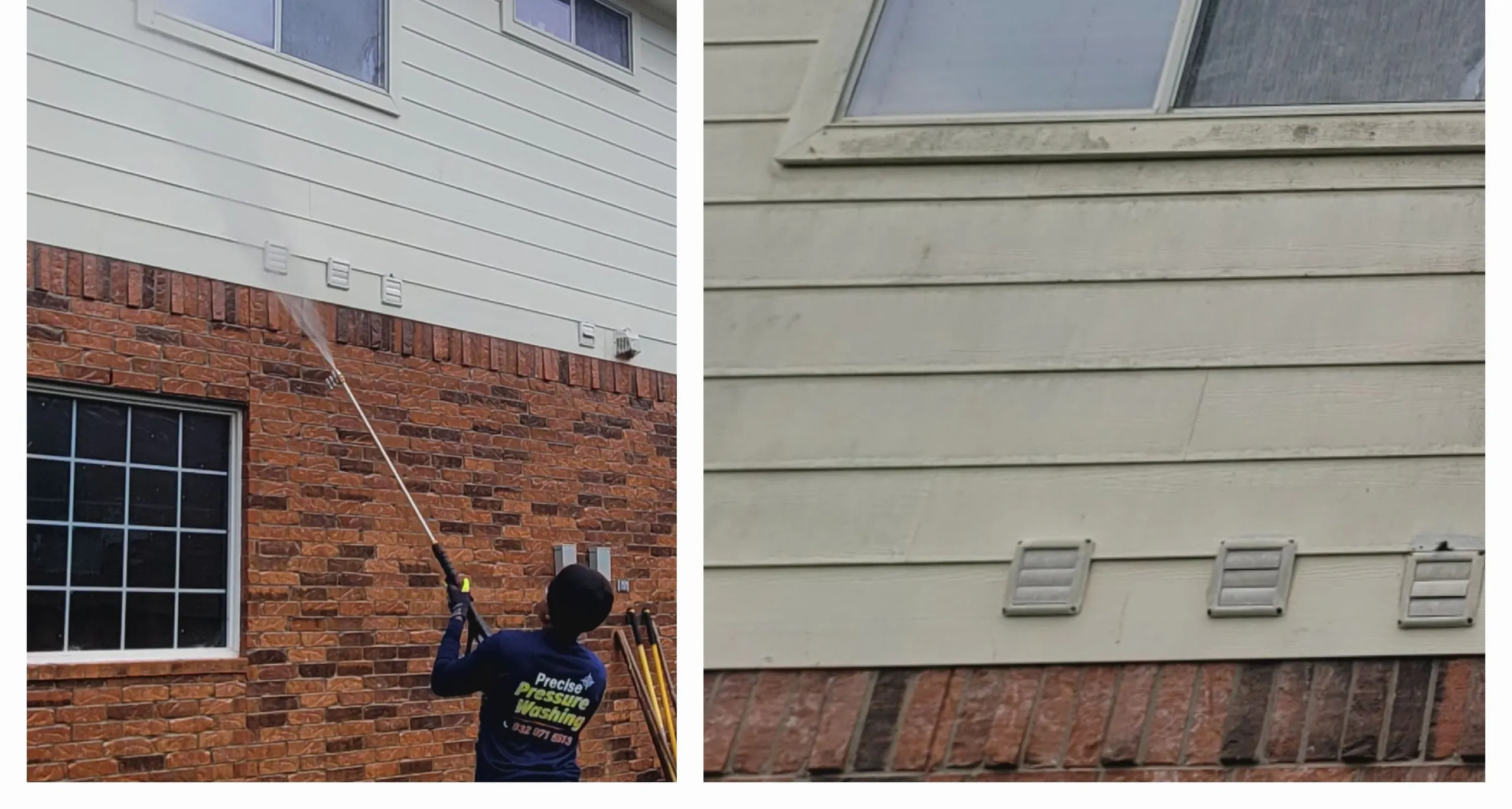 A person in a blue uniform with a "Precise Pressure Washing" logo is pressure washing a house. The house has beige siding and red brick. There are windows and vents visible on the house. The person is holding a pressure washing wand and spraying water onto the siding. Several other pressure washing tools are leaning against the brick wall.