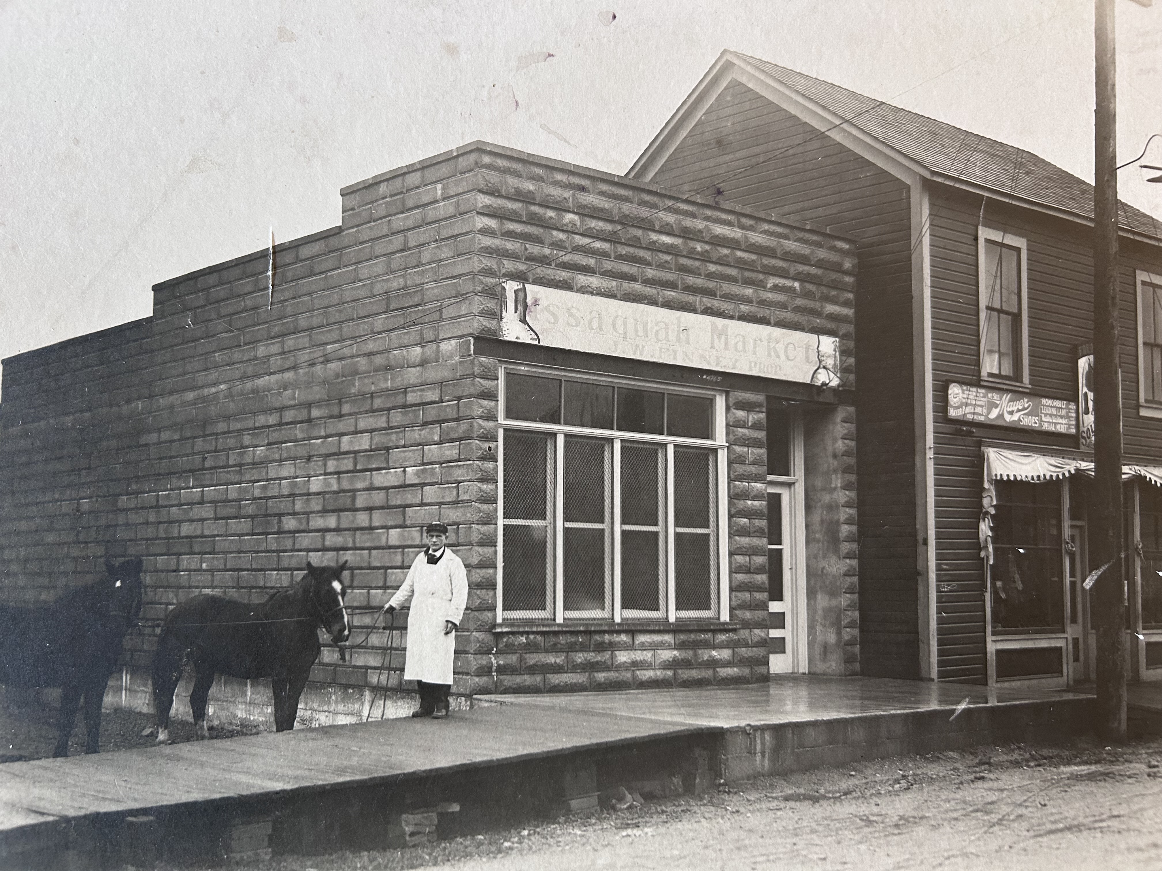 Our agency is the 3rd oldest building on Front Street. This photo is from 1910. The original use of the building was a butcher shop. The man holding the reins of the horse, is the original butcher shop owner.