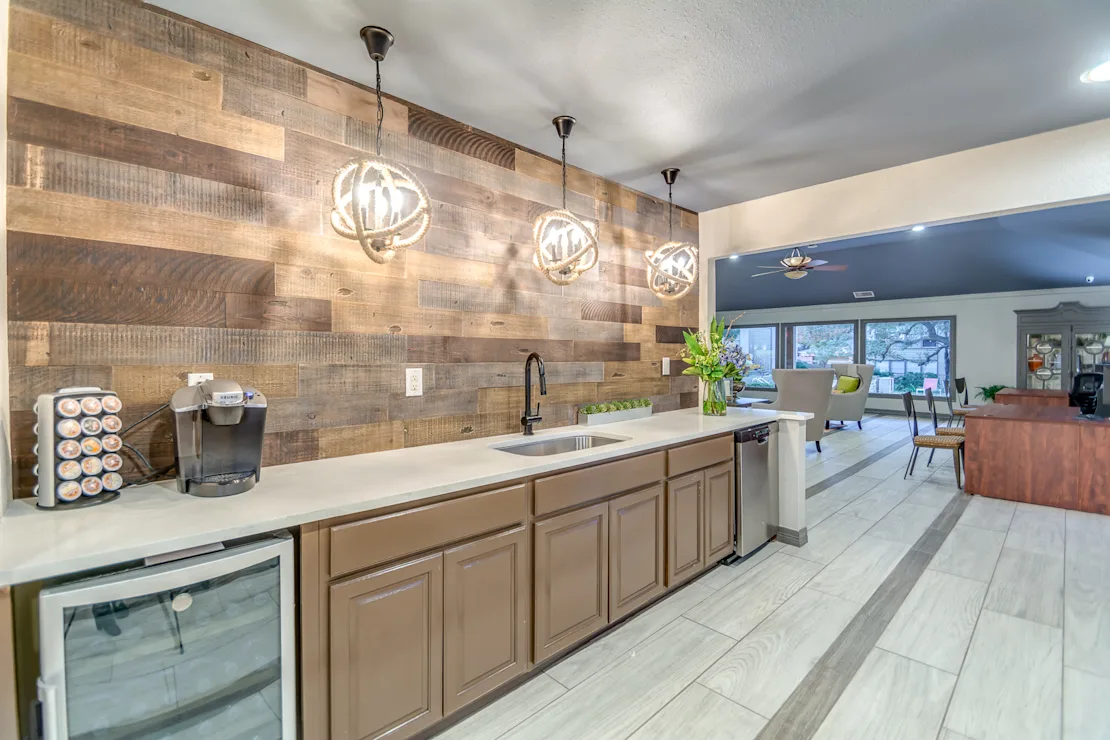 Coffee bar with spherical pendant lighting and wood accent wall