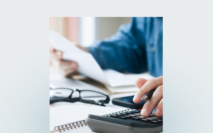 Close-up of an individual reviewing their taxes.