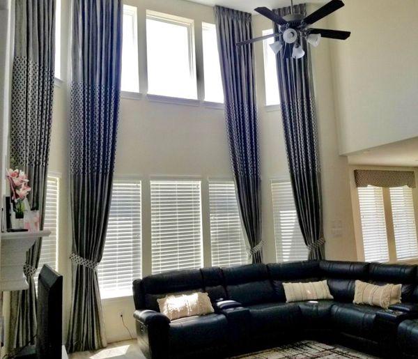 Are you ready to give your Katy, TX home a makeover? If so, decorate using these Wood Blinds with Custom Grey Silk Drapery Floating Panels with Tie Backs by Budget Blinds of Katy & Sugar Land. Your place will look amazing! #BudgetBlindsKatySugarLand #WoodBlinds #DraperyPanels #TieBacks #FreeConsulta