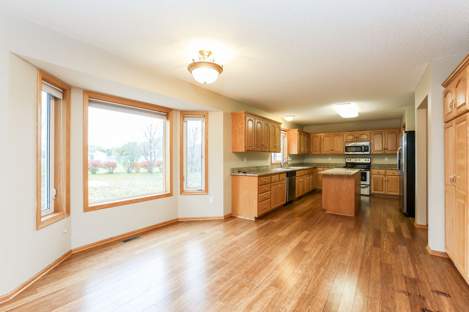 Kitchen with stainless steel appliances and prepping island plus breakfast nook at Invitation Homes Minneapolis.