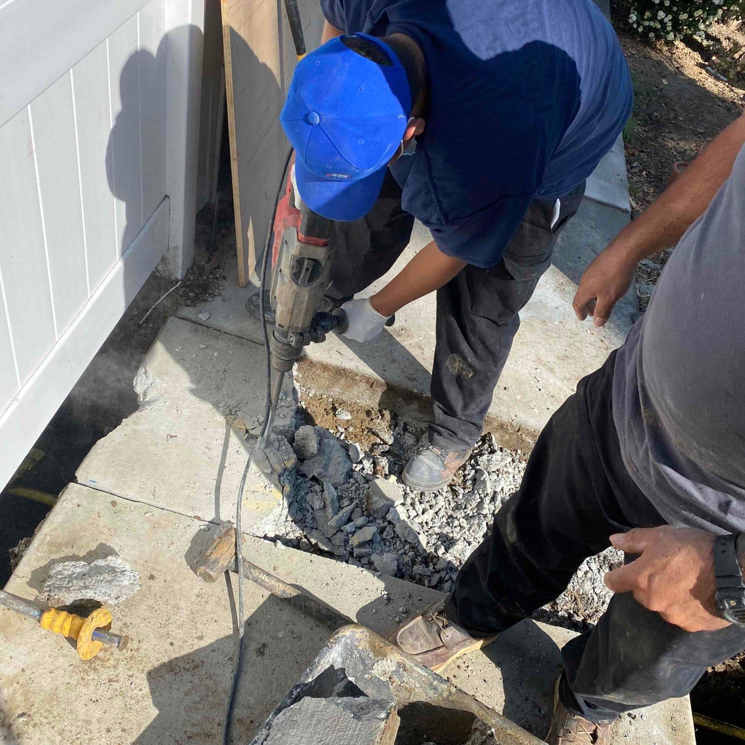 Cutting through the concrete.