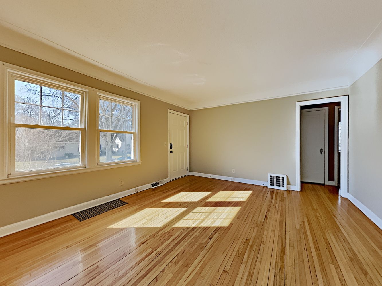 Comfortable living space with wood floors at Invitation Homes Minneapolis.