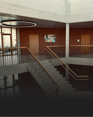 Interior shot of a nicely designed high school staircase.