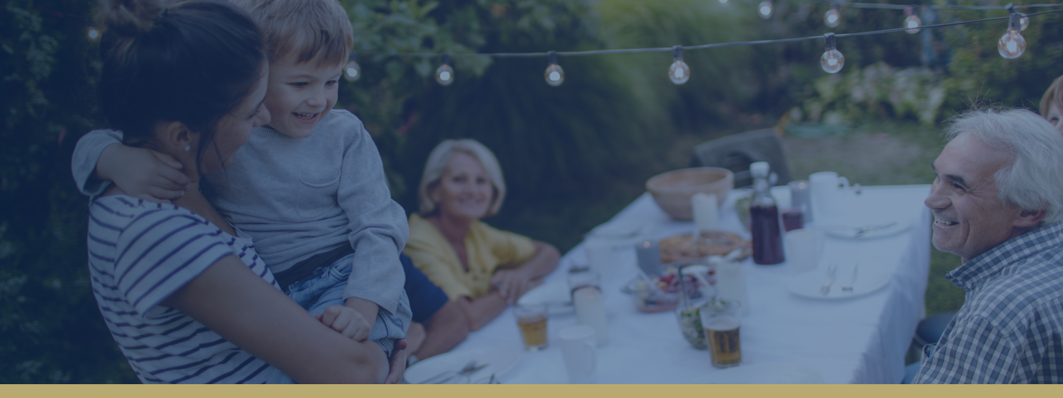 Happy family enjoying dinner in their backyard.