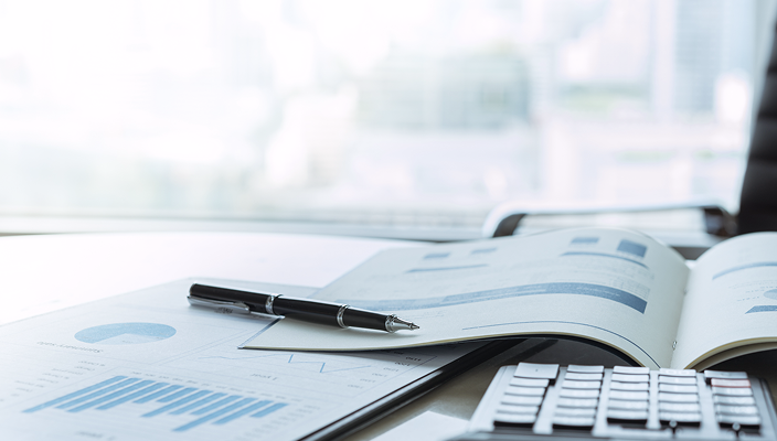 Open financial reports on a desk.