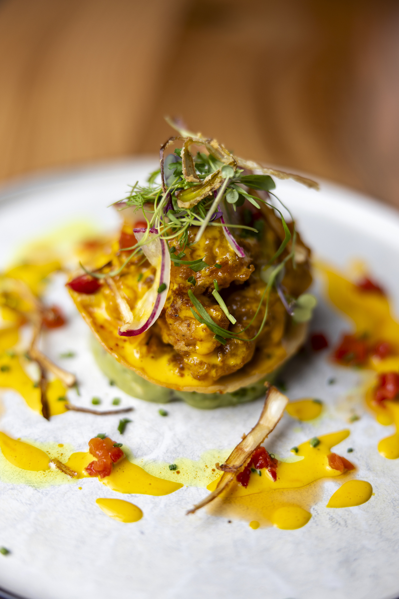 Crispy shrimp chicharr&oacute;n tostada topped with fresh ingredients, bright flavors, and a perfect crunch in every bite