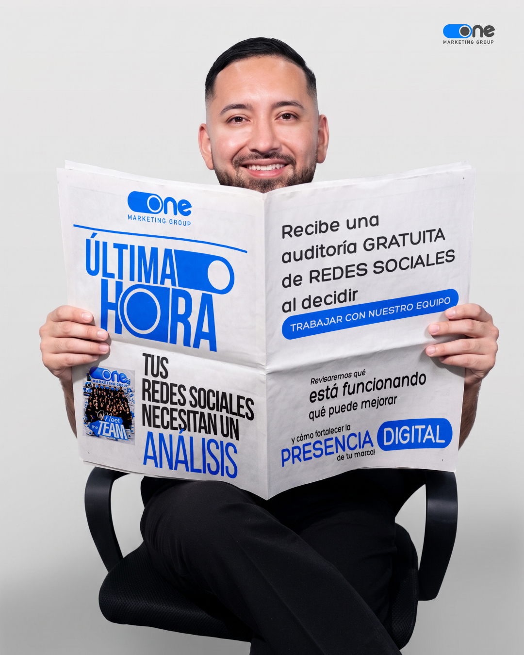 One Marketing Group CEO holding a newspaper feature highlighting agency growth and leadership.