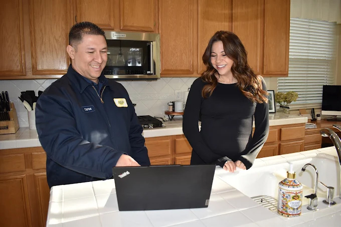 Dutton Plumbing, Cooling & Heating expert and a customer 