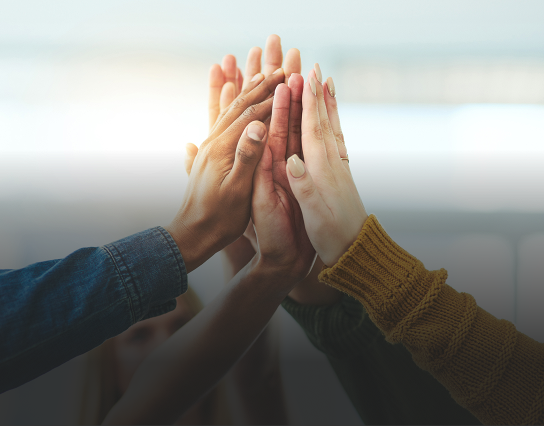 A team of volunteers giving each other a high five.