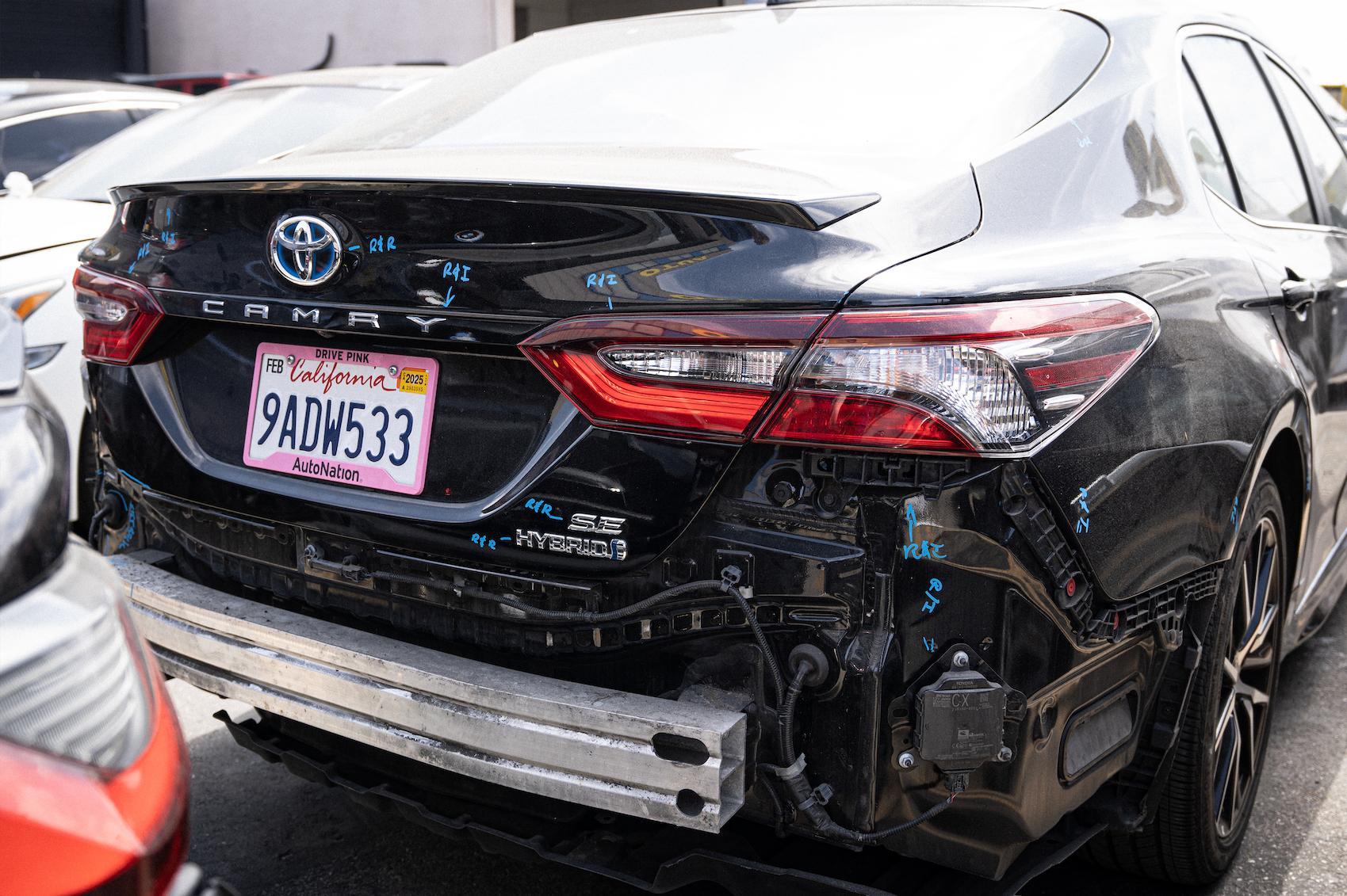 Detailed photo of Toyota Camry at auto body shop parking lot for collision repair