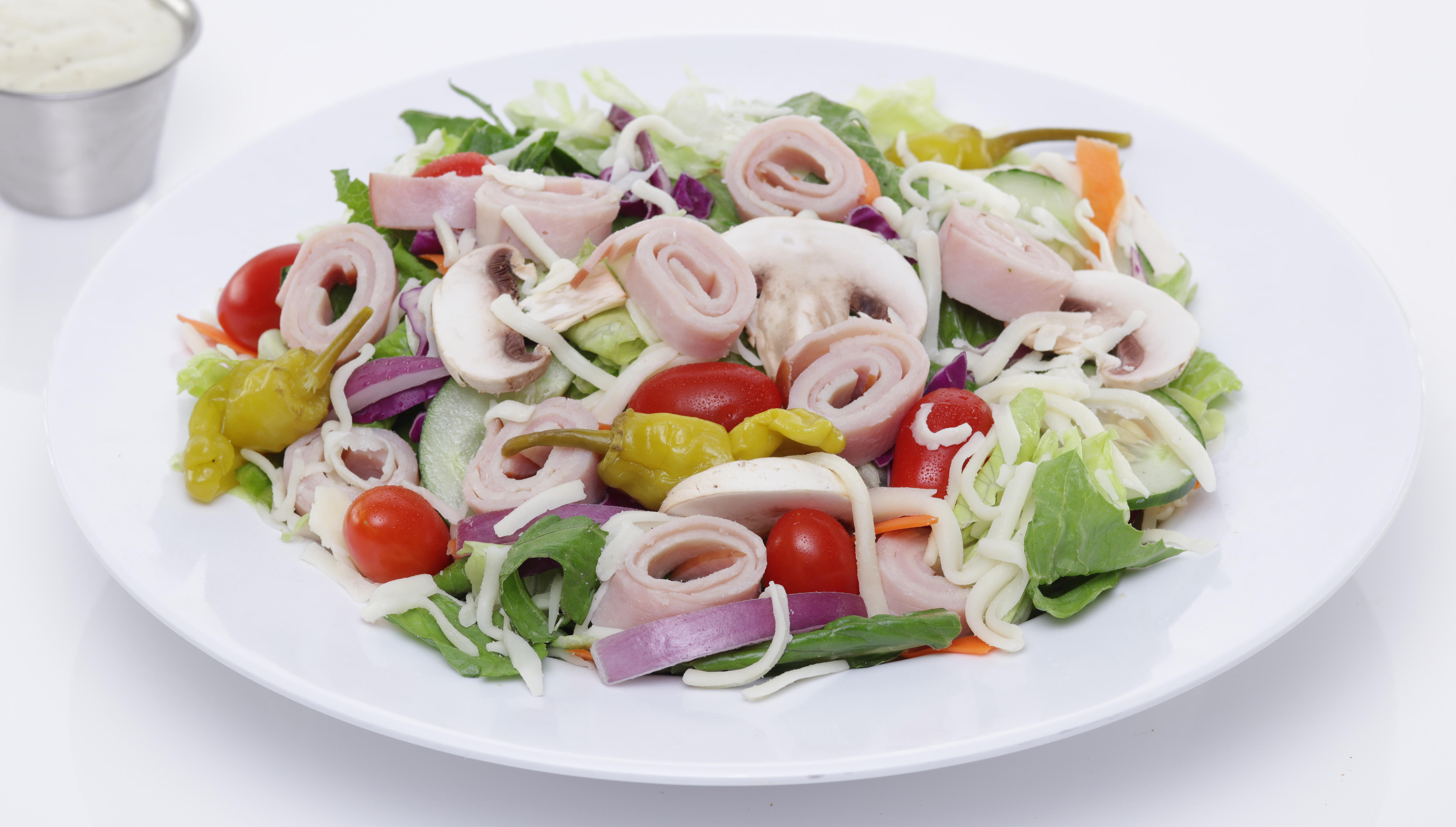 CHEF SALAD - Iceberg & romaine mix with tomatoes, mushrooms, red onions, cucumber, pepperoncini peppers, ham, turkey & mozzarella cheese.