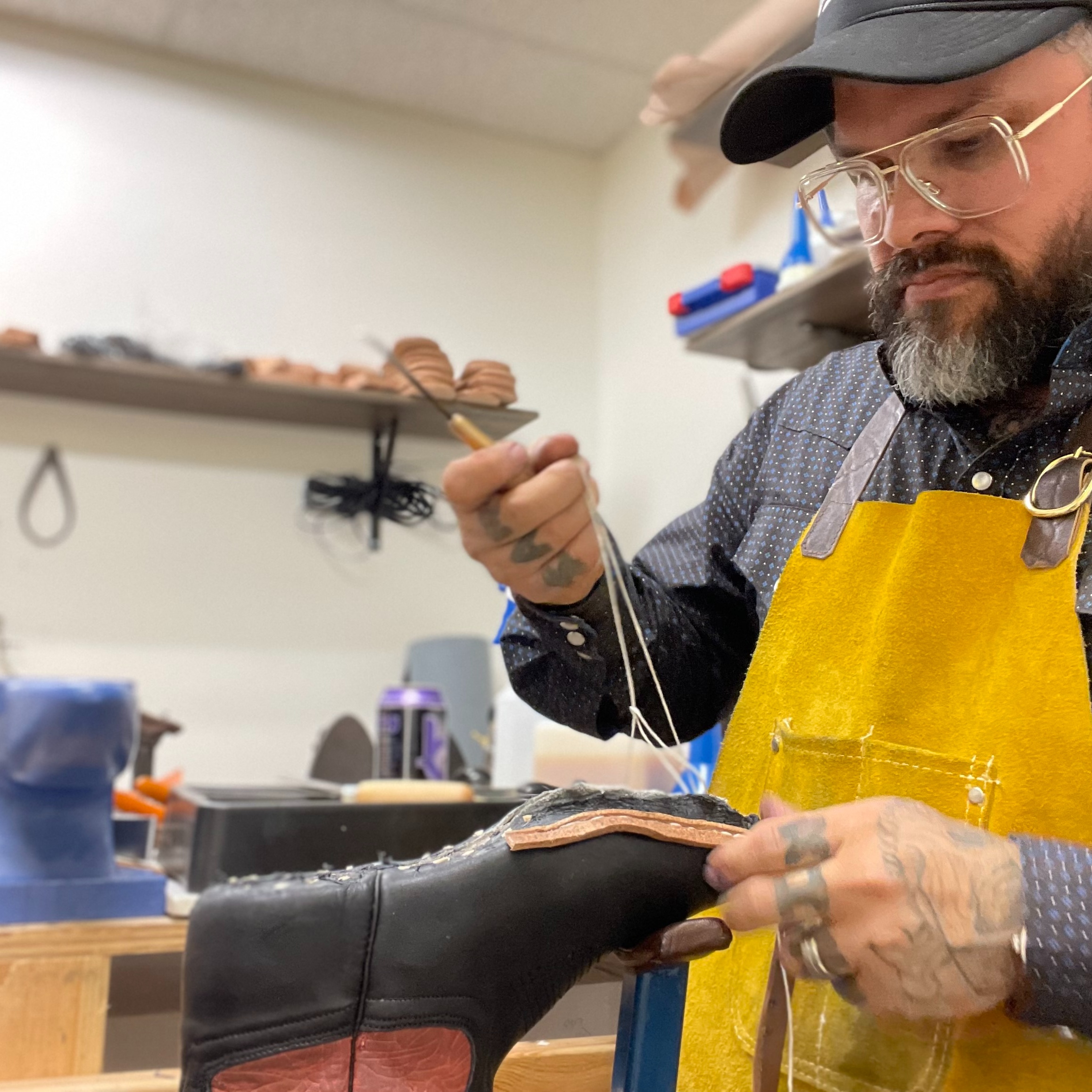 An Old Country bootmaker hand-stitches a custom leather cowboy boot inside the Las Vegas workshop. 