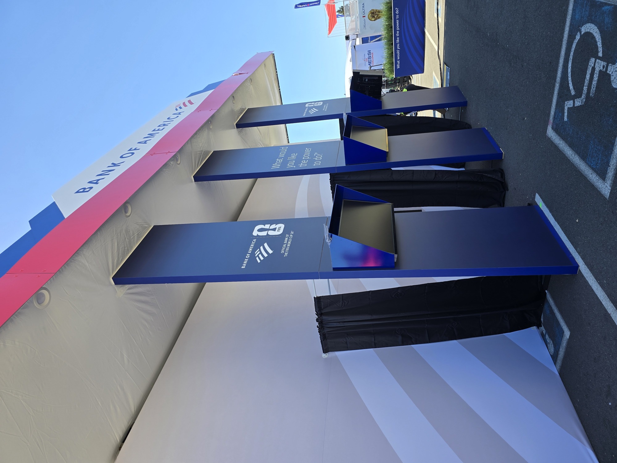 Bank of America event pavilion exterior featuring custom digital kiosks, branded architectural columns, and integrated exhibit graphics.