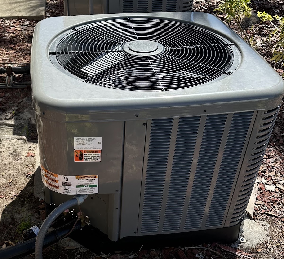 Outdoor residential air conditioning condenser installed to provide dependable cooling and indoor comfort.