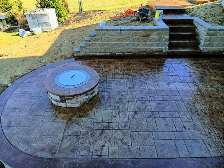 The owners of this home in Blue Ash, Ohio wanted a new concrete patio in their backyard. To get to it, they also wanted steps running down a hill on the side of the house. Finally, we also created a fire pit using stamped concrete techniques. This was a big project, but the end result turned out great! If you would you like to change your backyard, call us to discuss your plans.