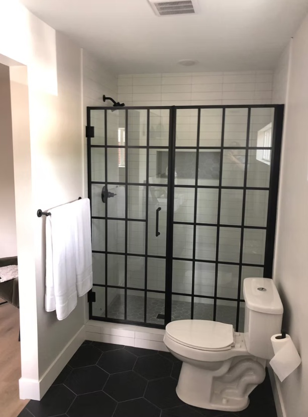 Love how this all came together, the matte black grid shower doors really steal the show as a bold architectural feature, while the large black hex floor tile adds that moody, modern vibe. The whole space feels clean, stylish, and really intentional from top to bottom.Ready to get started? Let’s talk!