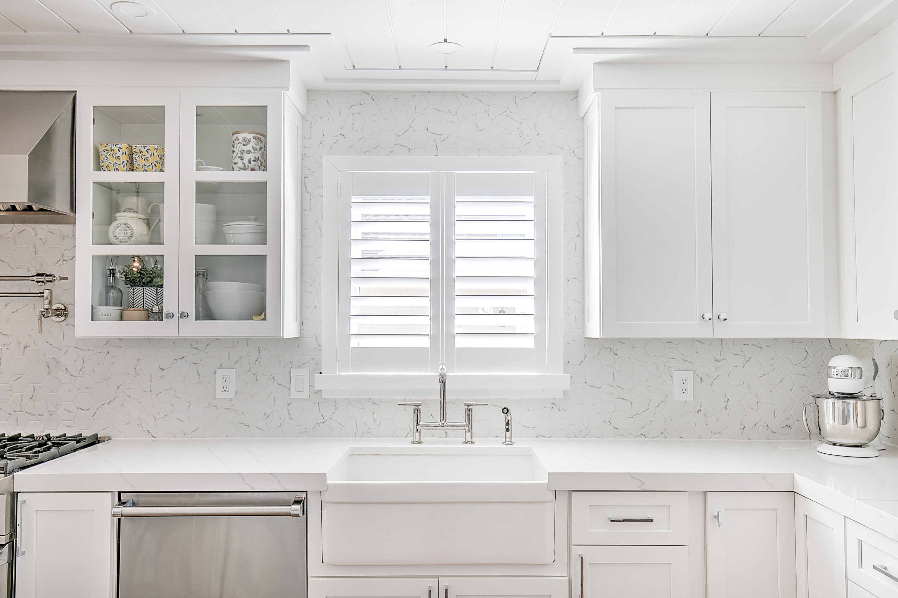 You can never go wrong with classic plantation shutters! Not only do they provide excellent light control and privacy, but they also enhance the kitchen's brightness and create a seamless, polished look!