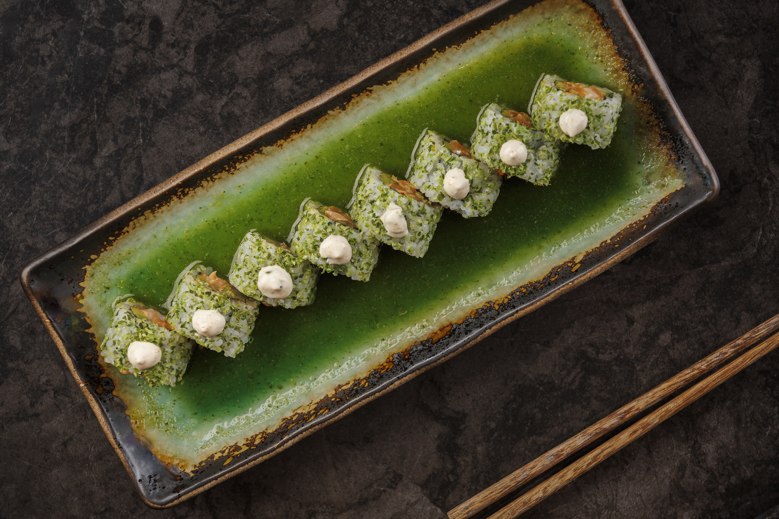 Mr. H Jade Roll sushi featuring spicy salmon, avocado, cucumber, jalapeño ponzu, wasabi crema, and f 