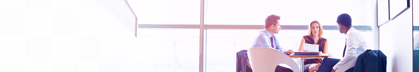 A team of three advisors in a meeting.