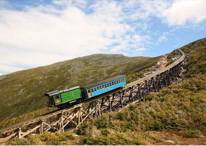 Train riding up an uphill track.